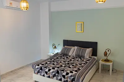 a bedroom with a bed with a black and white comforter at Spacious and Chic 3 Bedroom Appartment Beautiful Rooftop Terrace Great location to explore Hurghada in Hurghada