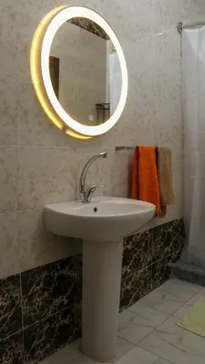 a bathroom with a sink and a mirror at Spacious and Chic 3 Bedroom Appartment Beautiful Rooftop Terrace Great location to explore Hurghada in Hurghada