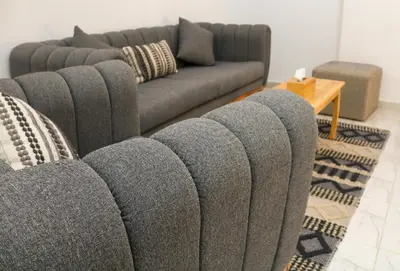 a living room with a couch and a table at Spacious and Chic 3 Bedroom Appartment Beautiful Rooftop Terrace Great location to explore Hurghada in Hurghada