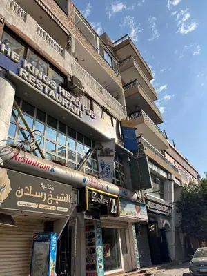 a building with signs on the side of it at Nile View Luxe Stay , Walk to Luxor Temple in Luxor