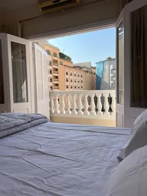 a bedroom with a bed and a view of a city at Nile View Luxe Stay , Walk to Luxor Temple in Luxor