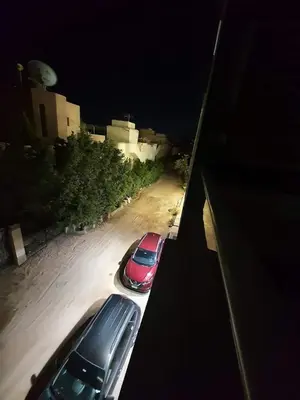 two cars parked in a parking lot at night at Kite Lodging Hotel in Hurghada