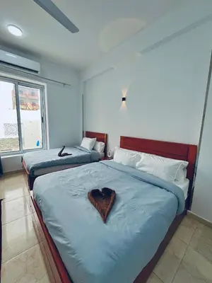 a bedroom with two beds with a heart on them at el rabia - private rooms in Luxor
