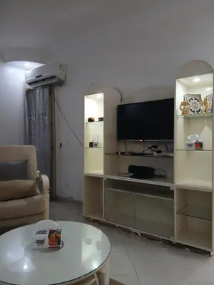 a living room with a television and a table at Arrabia in front of Beirut Hotel in Hurghada