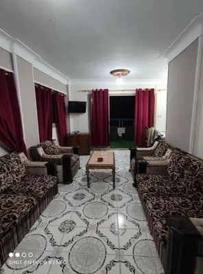 a living room with couches and a table at الاقصر in Luxor