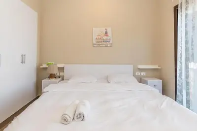 a white bed with two pairs of slippers on it at 4 Bdr Villa with private heated pool in Sabina in Hurghada