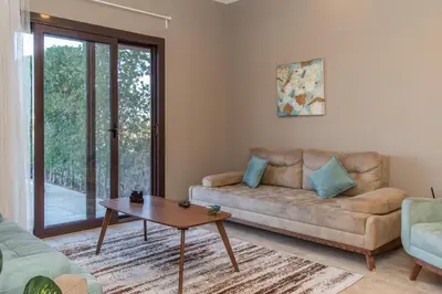 a living room with a couch and a table at 4 Bdr Villa with private heated pool in Sabina in Hurghada