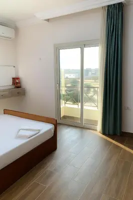 a bedroom with a bed and a large window at casablanca resort in Hurghada