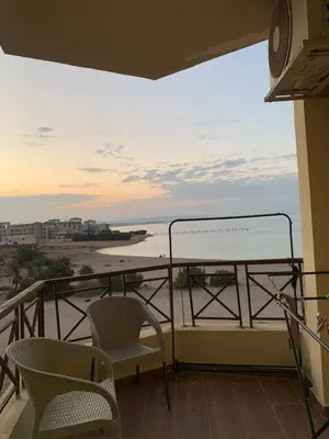 a balcony with chairs and a view of the ocean at casablanca resort in Hurghada
