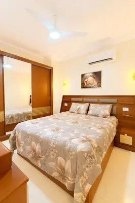 a bedroom with a large bed and a mirror at Oscar apartment 5 in Luxor