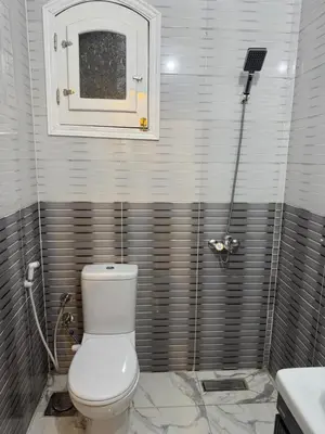 a bathroom with a white toilet and a sink at Peace Homes in Quseir