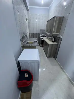 a small kitchen with a sink and a counter at Peace Homes in Quseir