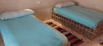two beds sitting next to each other in a room at Nile Domes Guest House in Luxor