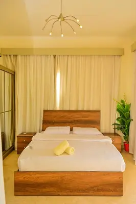 a bedroom with a large bed with white sheets at Breathtaking Villa in El Gouna 15 in Hurghada