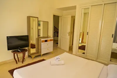 a living room with a white couch and a tv at Breathtaking Villa in El Gouna 15 in Hurghada