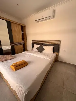 a bedroom with a white bed with a towel on it at 201 Aqua Blue Bay in Hurghada