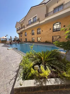 a swimming pool in front of a building at 201 Aqua Blue Bay in Hurghada