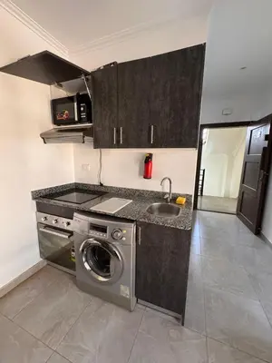 a kitchen with a washing machine and a sink at 201 Aqua Blue Bay in Hurghada