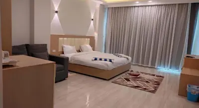 a bedroom with a bed and a couch in a room at Hurghada Aqua-Mirage Beach Resort in Hurghada