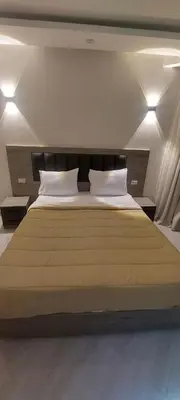 a bedroom with a large bed with two pillows at Hurghada Aqua-Mirage Beach Resort in Hurghada