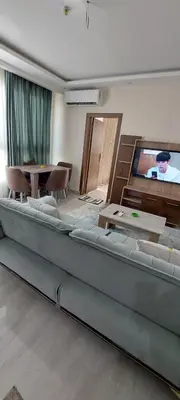 a large couch in a living room with a tv at Hurghada Aqua-Mirage Beach Resort in Hurghada
