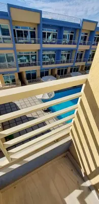 a balcony of a building with a blue building at Hurghada Aqua-Mirage Beach Resort in Hurghada