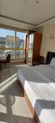 a bedroom with a large bed and a balcony at Hurghada Aqua-Mirage Beach Resort in Hurghada