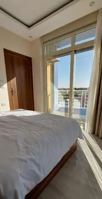 a bedroom with a large bed and a large window at Hurghada Aqua-Mirage Beach Resort in Hurghada