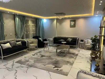a living room with couches and tables and a rug at Furnished apartment for rent in Abū Tīj
