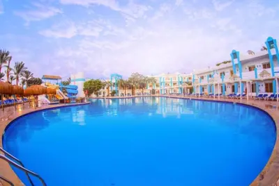 a large swimming pool at a resort with blue water at فندق ميراج باي اكوا بارك in Hurghada