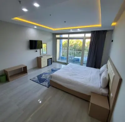 a bedroom with a bed and a television in it at فندق ميراج باي اكوا بارك in Hurghada