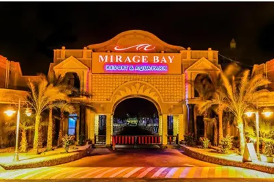 a entrance to a miregas bay restaurant at night at فندق ميراج باي اكوا بارك in Hurghada