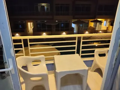 a balcony with chairs and tables on a boat at فندق ميراج باي اكوا بارك in Hurghada