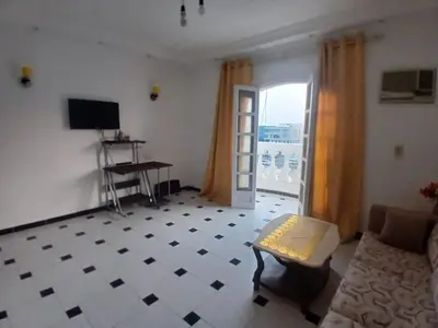 a living room with a couch and a table and a window at Rent Mubarak 2 in Hurghada