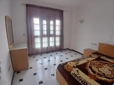 a bedroom with a bed and a large window at Rent Mubarak 2 in Hurghada