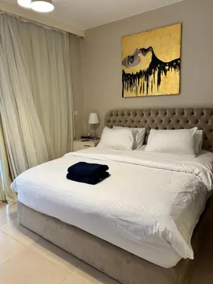 a bedroom with a large bed with a blue shirt on it at M10-2b-04 mangrove in Hurghada