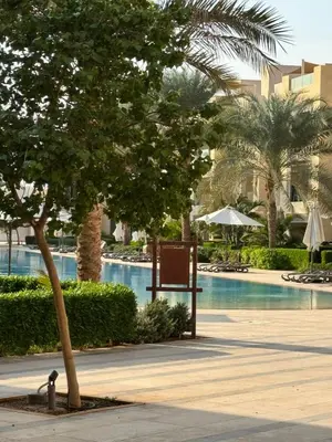 a tree and a sign next to a swimming pool at M10-2b-04 mangrove in Hurghada