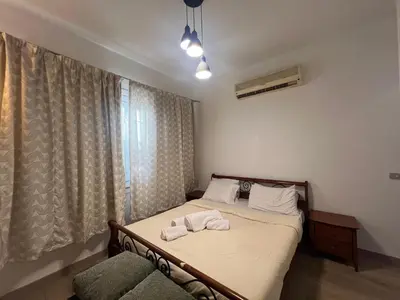 a bedroom with a bed with towels on it at Cozy South Marina 2Bdr with Pool Access in Hurghada