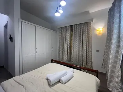 a bedroom with a bed with two towels on it at Cozy South Marina 2Bdr with Pool Access in Hurghada