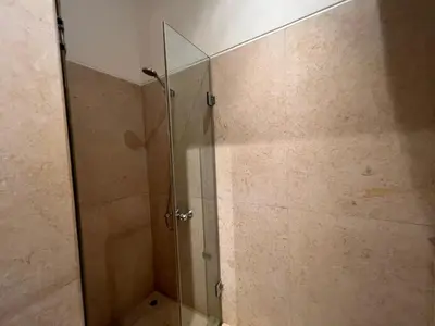 a shower with a glass door in a bathroom at Cozy South Marina 2Bdr with Pool Access in Hurghada