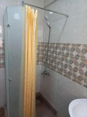a shower with a glass door next to a sink at Apartment compound west sayed Al kawthar in Hurghada