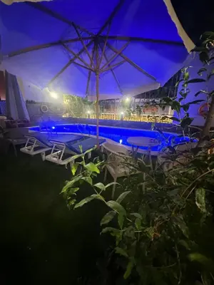 a swimming pool with an umbrella and chairs and a pool at Interstar Luxury Apartments in Hurghada