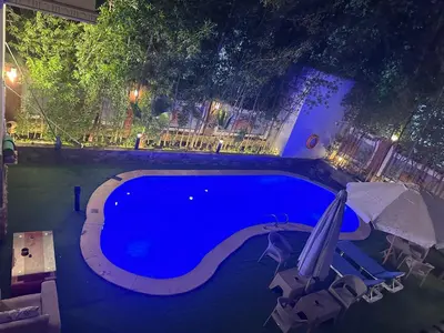 a swimming pool at night with an umbrella at Interstar Luxury Apartments in Hurghada