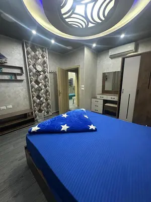 a bedroom with a blue bed with a round ceiling at Interstar Luxury Apartments in Hurghada