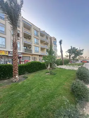 a large apartment building with a lawn in front of it at Interstar Luxury Apartments in Hurghada