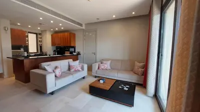 a living room with a couch and a table at Scenic Cosy Nest - Infinity Pool - Ancient Sands in Hurghada
