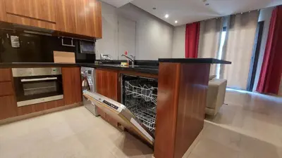 a kitchen with an empty dishwasher in the middle at Scenic Cosy Nest - Infinity Pool - Ancient Sands in Hurghada