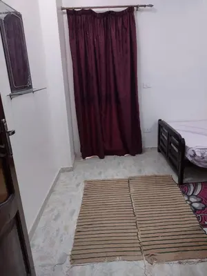 a bedroom with a bed and a red curtain at شقة الغردقة in Hurghada