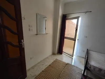 an empty room with a door and a window at شقة الغردقة in Hurghada