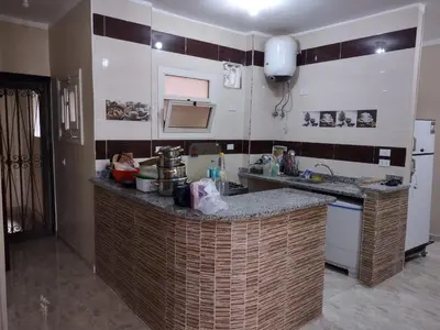 a kitchen with a counter with a sink and a counter top at شقة الغردقة in Hurghada